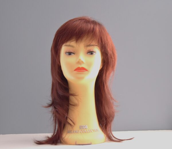 Long red synthetic wig on mannequin head