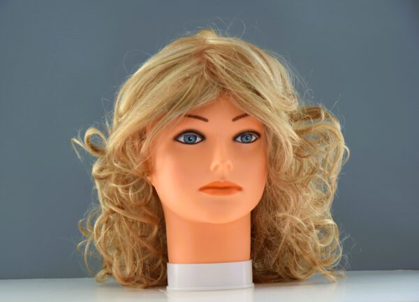medium length blonde synthetic wig on mannequin head