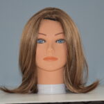 Medium length brown synthetic wig on mannequin head