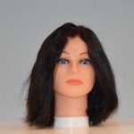 medium length black synthetic wig on mannequin head