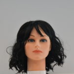 medium length black synthetic wig on mannequin head